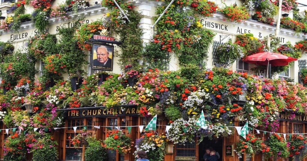 The Churchill Arms pub in London covered in flowers and plants