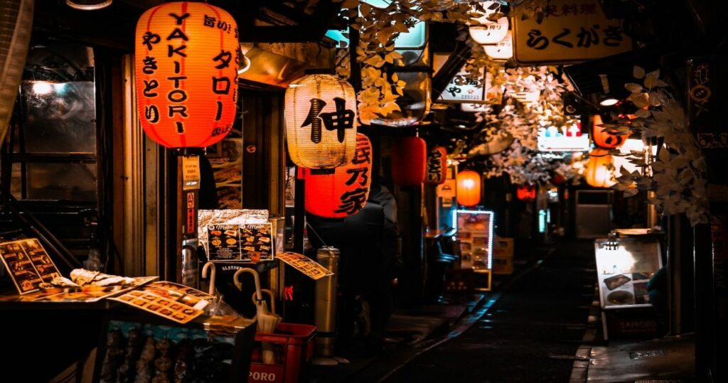 Restaurants and bars in Tokyo lit up at night along the streets