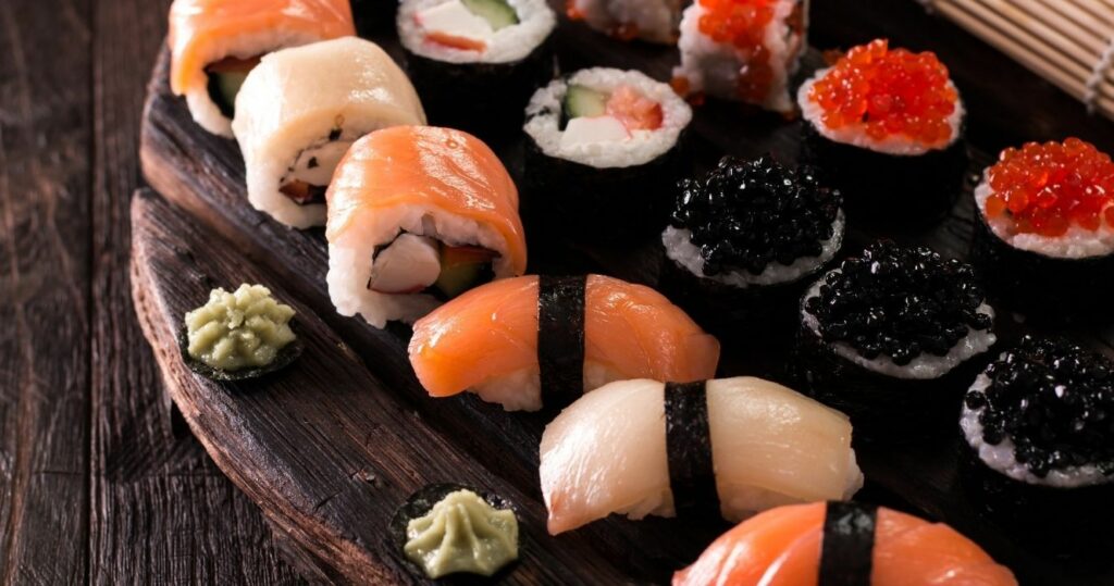 A platter full of mixed sushi