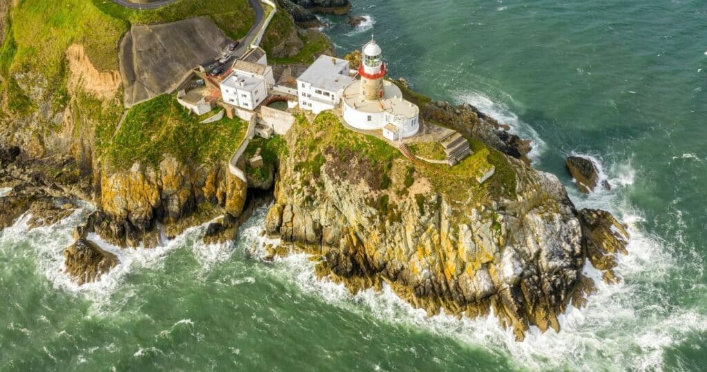 a lighthouse on the cliffs in howth, ireland