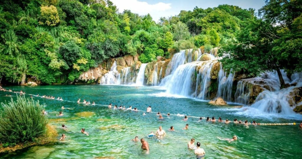 people swimming in the falls in krka national park, plitvice, croatia