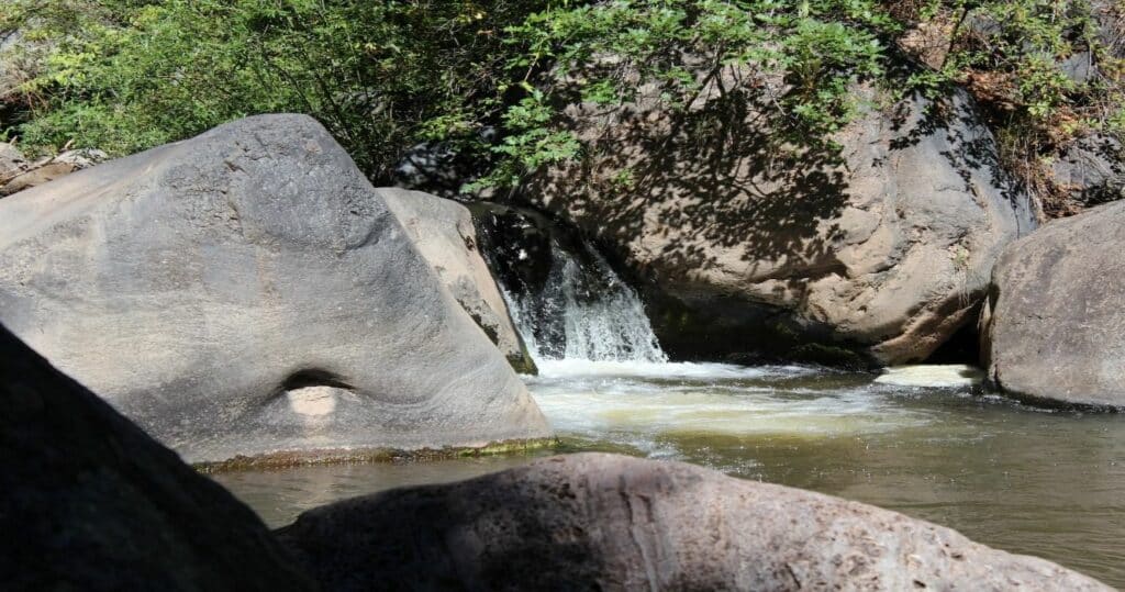 A small waterfall flowing into the waters of Jemez Springs in New Mexico, USA