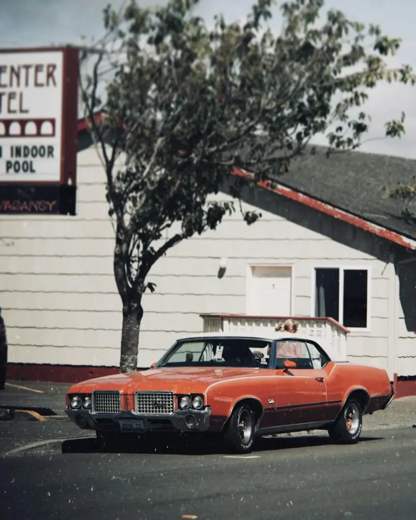 Classic vintage muscle car parked outside a retro motel in Portland, Oregon.