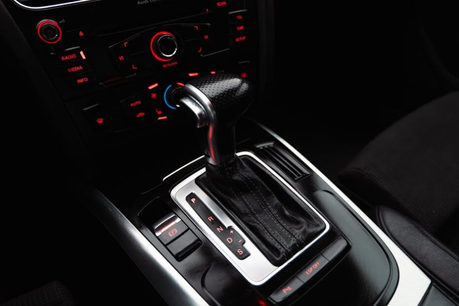 Close-up shot of a modern car gear shift lever and control panel, highlighting details.