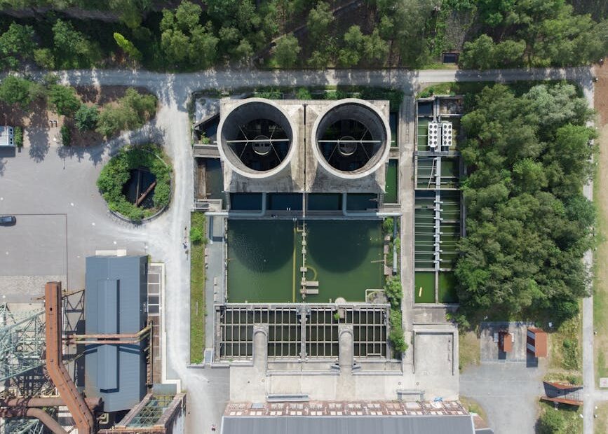 Aerial view of industrial water treatment facility surrounded by greenery in Bochum, Germany.
