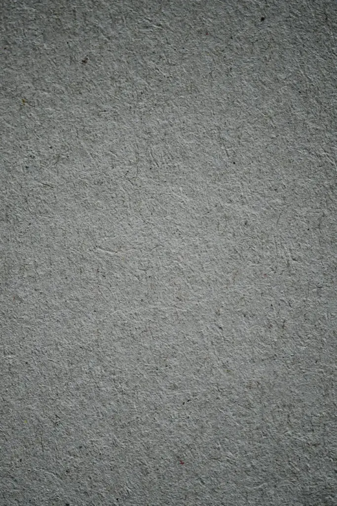 A vertical shot of a textured gray concrete surface, ideal for background use.
