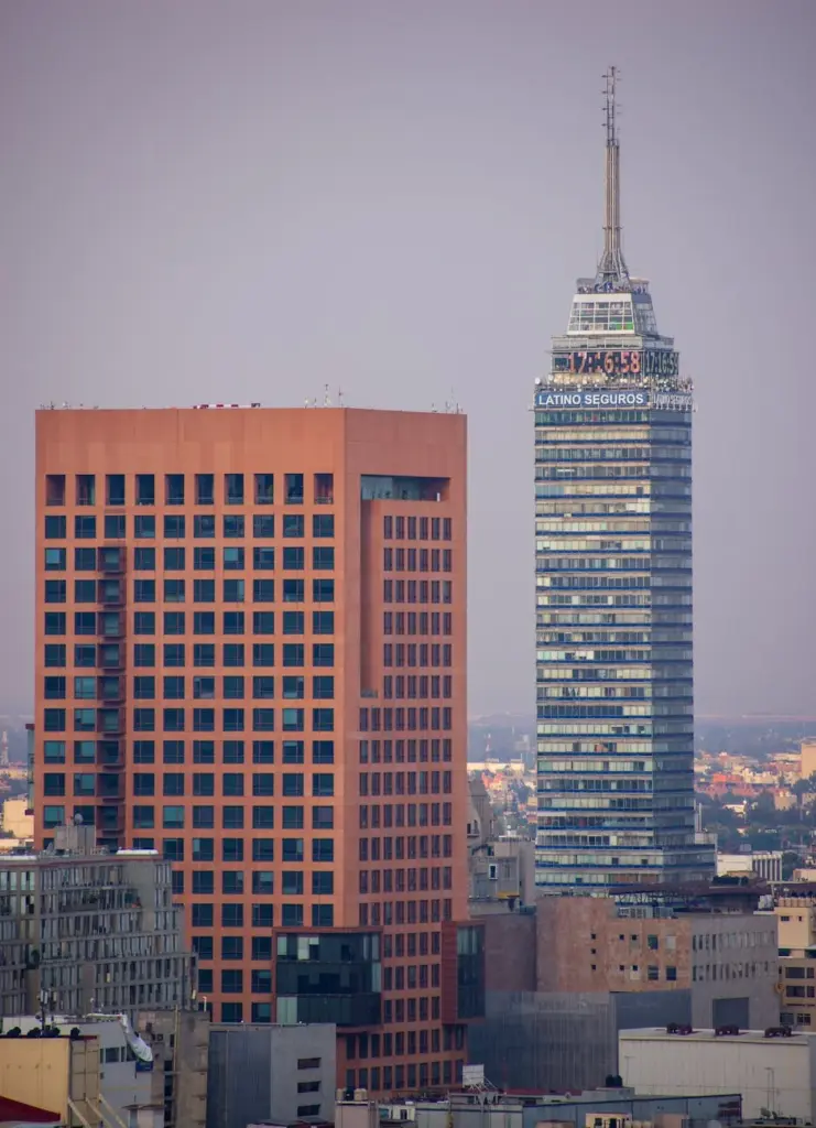 Iconic Torre Latinoamericana and neighboring skyscraper in Mexico City's skyline.