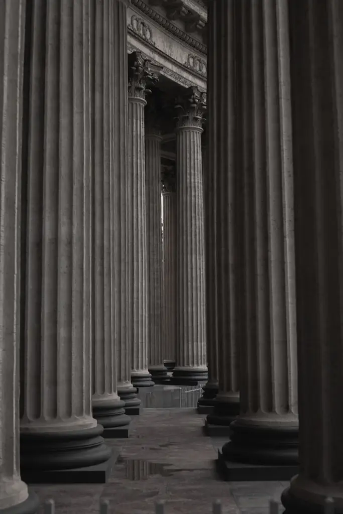 A dramatic perspective of classic stone columns in an old architectural setting.