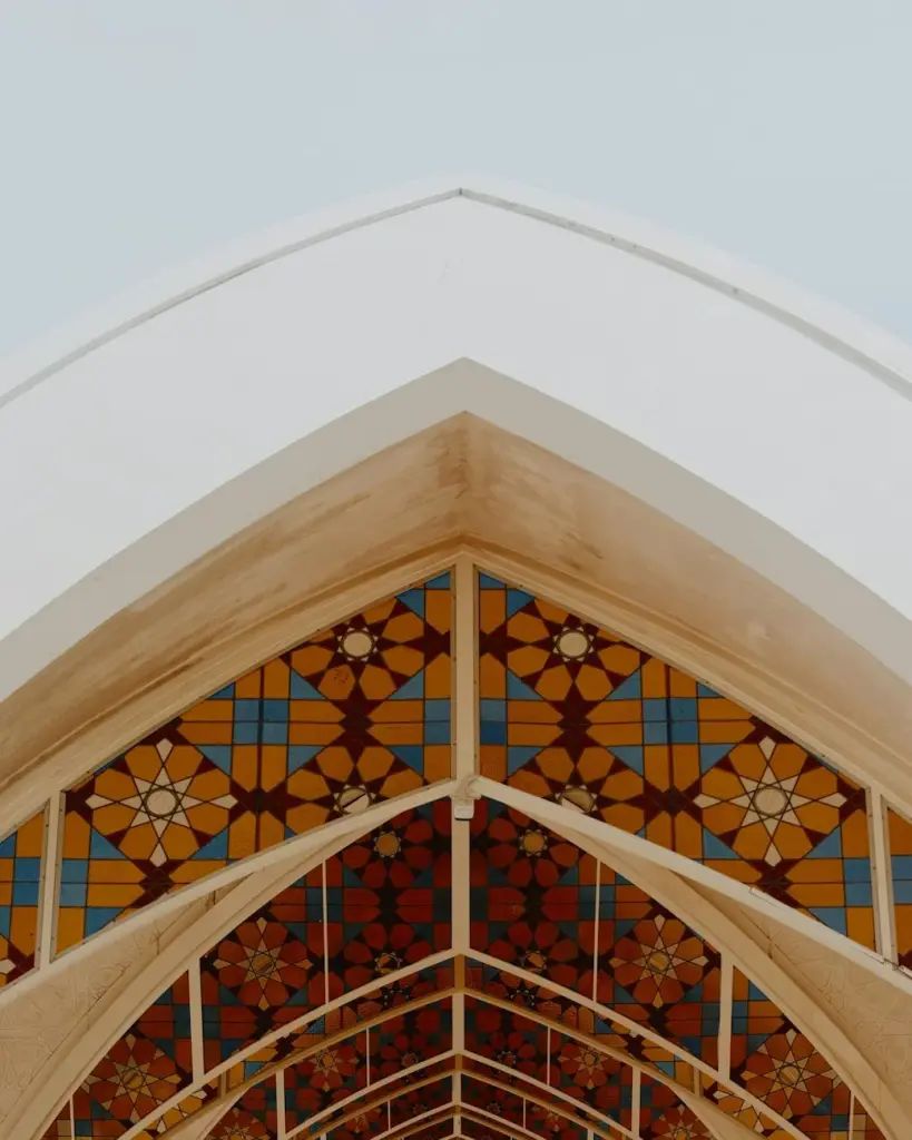 Intricate geometric patterns on an Islamic architectural ceiling, showcasing modern design influences.