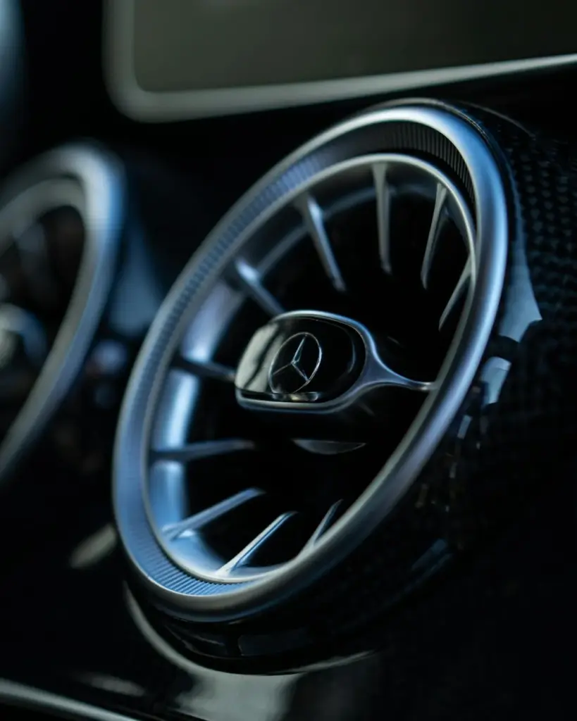 Detailed close-up of a Mercedes-Benz car air vent, showcasing sleek design and style.