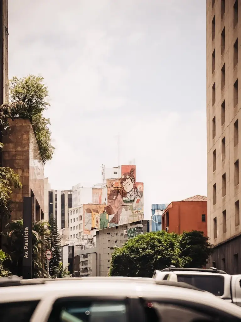 Captivating view of Avenida Paulista with urban art and skyscrapers in São Paulo, Brazil.