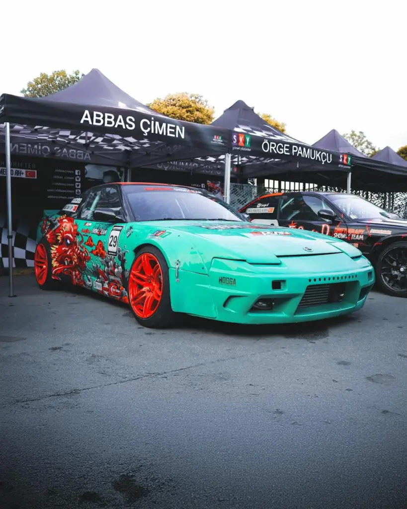 Vibrant custom Nissan car displayed at Ankara Auto Show. Eye-catching design and colors.
