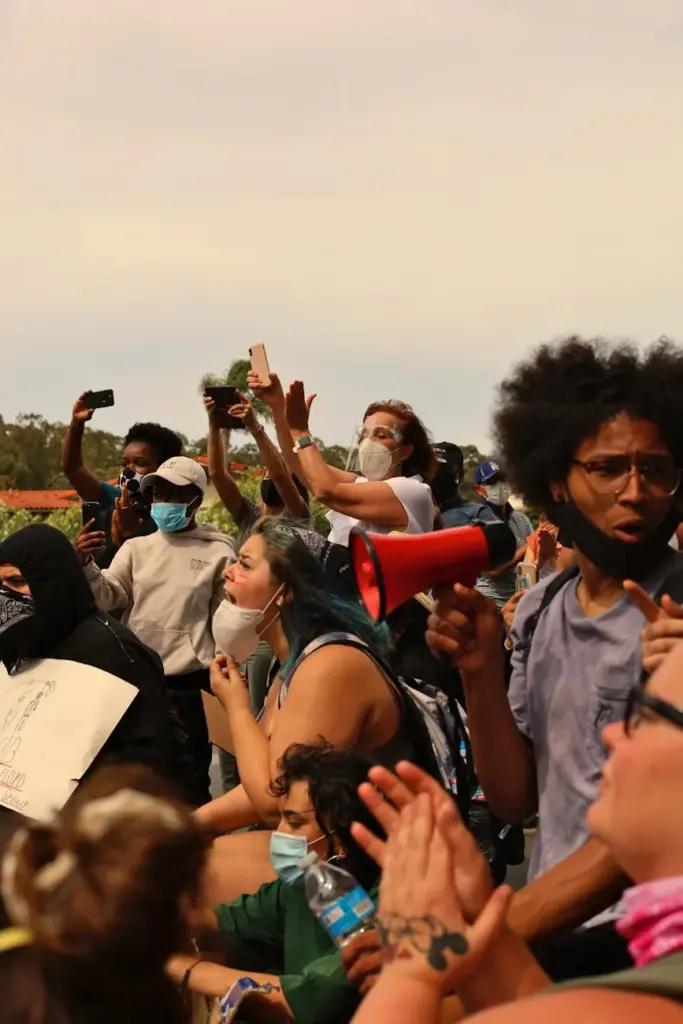 A vibrant crowd gathers for a protest rally in Los Angeles, showing activism and unity.