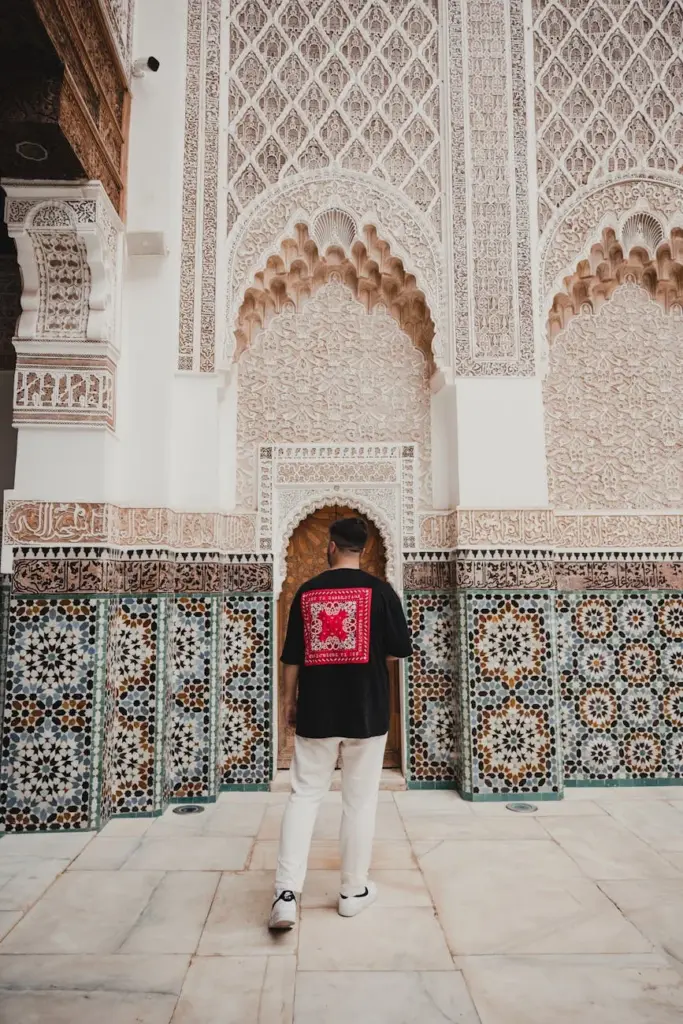 Elegant Moroccan architecture with a person admiring intricate tile designs.