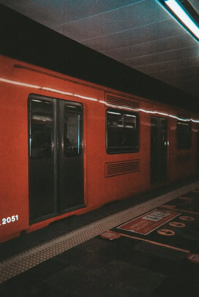 Orange subway train at a station in Mexico City, highlighting urban transportation in CDMX.