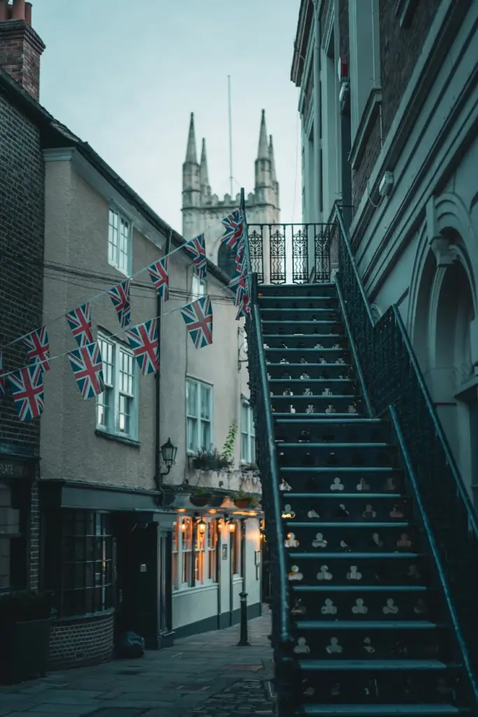 Charming street in Windsor, UK, featuring historic architecture and Union Flags.
