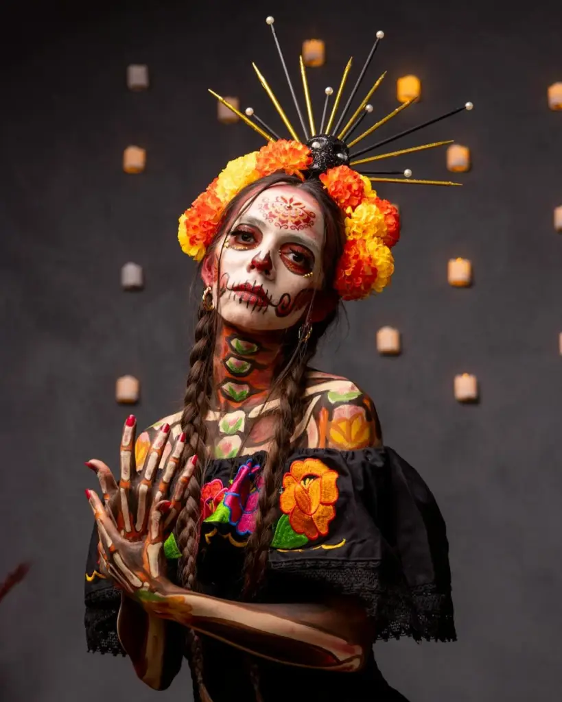 Artistic portrait of a Catrina with makeup and flowers for Dia de los Muertos in Mexico City.