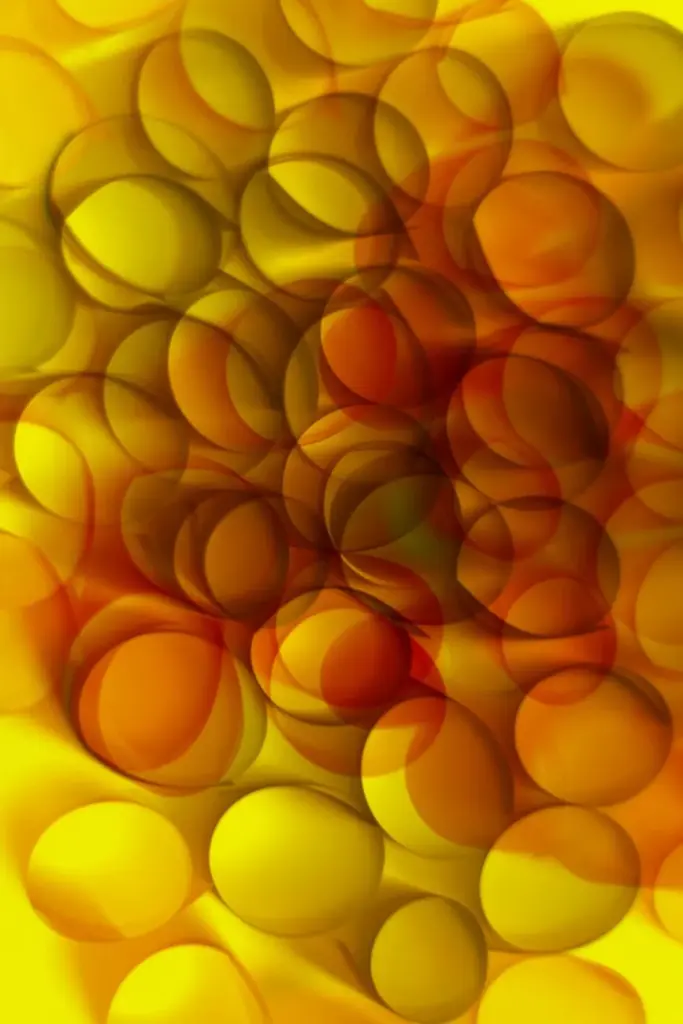 Vibrant abstract art with overlapping yellow and orange circles creating a dynamic pattern.