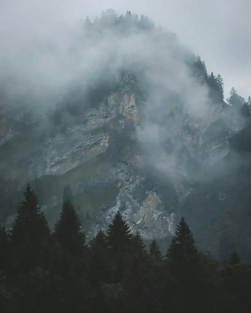 A dramatic, moody view of the fog-covered mountains in Sixt-Fer-à-Cheval, France.