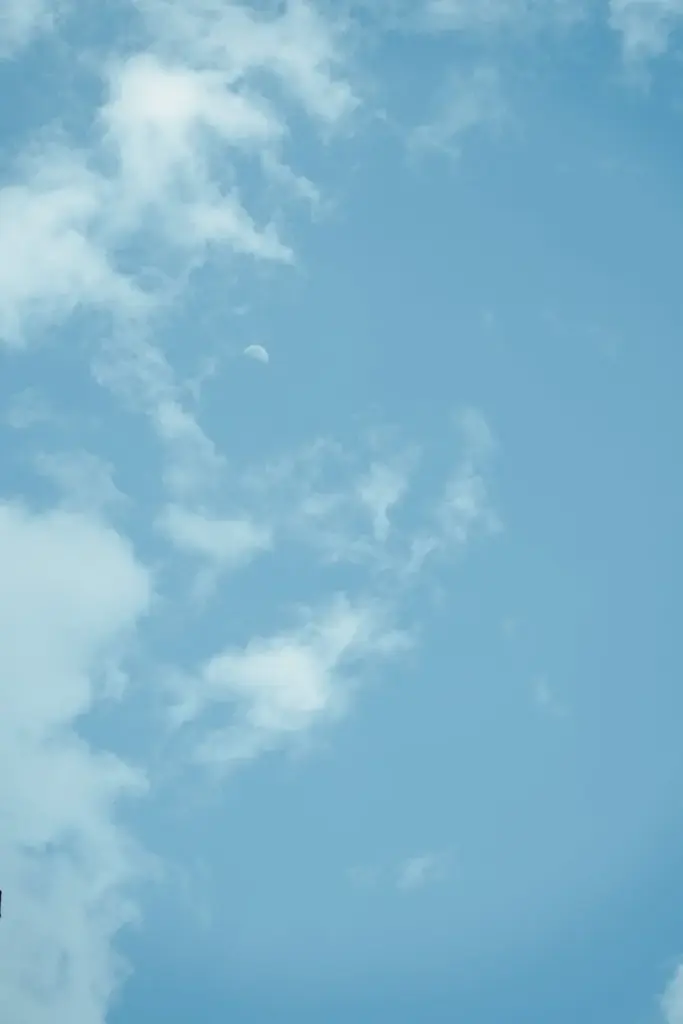 A clear blue sky featuring light cirrus clouds on a sunny day, perfect for backgrounds.