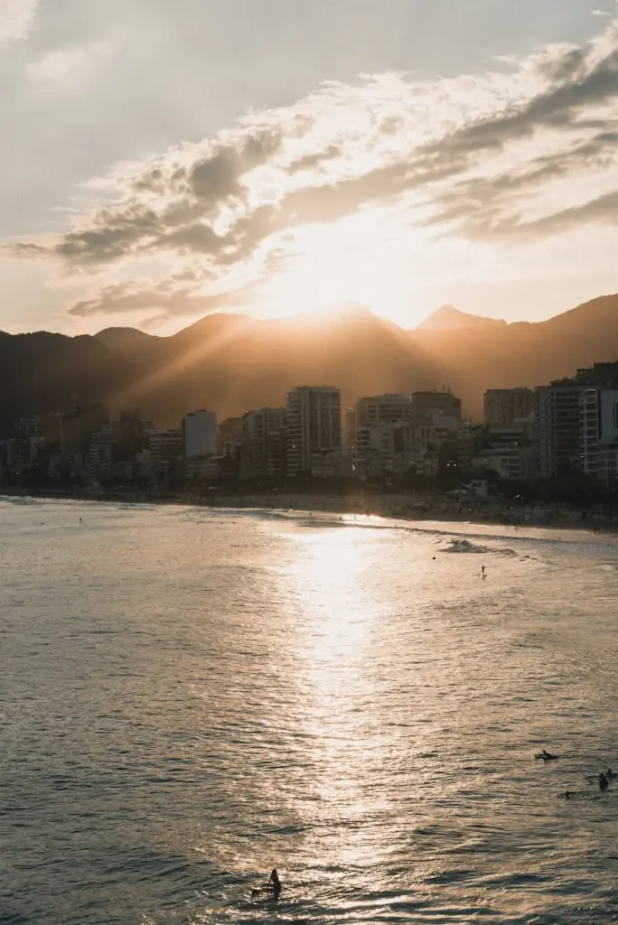 A picturesque sunset illuminating the skyline and coastline of Rio de Janeiro, Brazil.