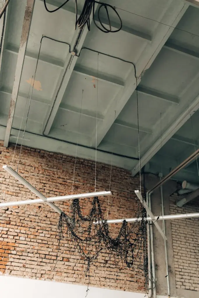 A modern industrial warehouse with high ceilings and exposed wiring, highlighting contemporary interior design trends.