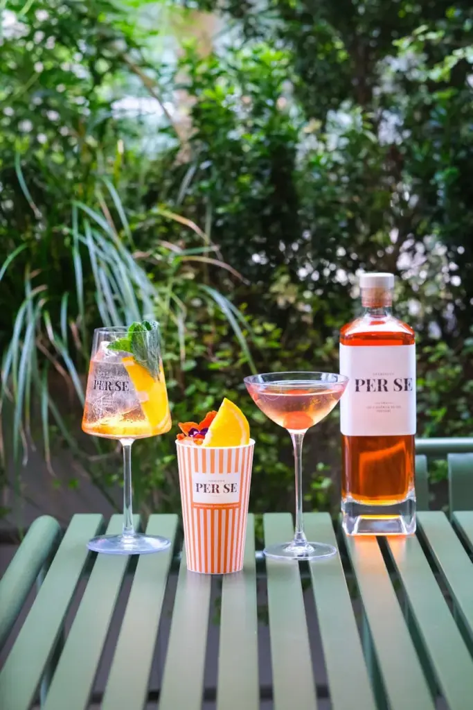 Enjoy vibrant cocktails outdoors in a London garden setting. Perfect for summer relaxation.
