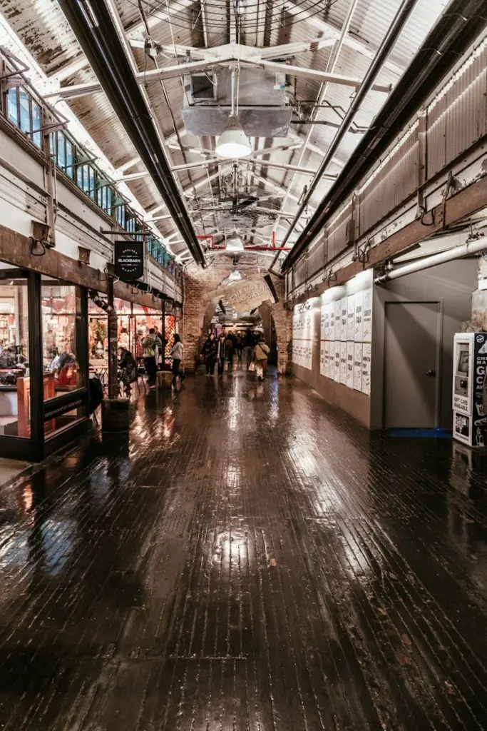 Explore the bustling interior of Chelsea Market, capturing vibrant shops and visitors in New York City.