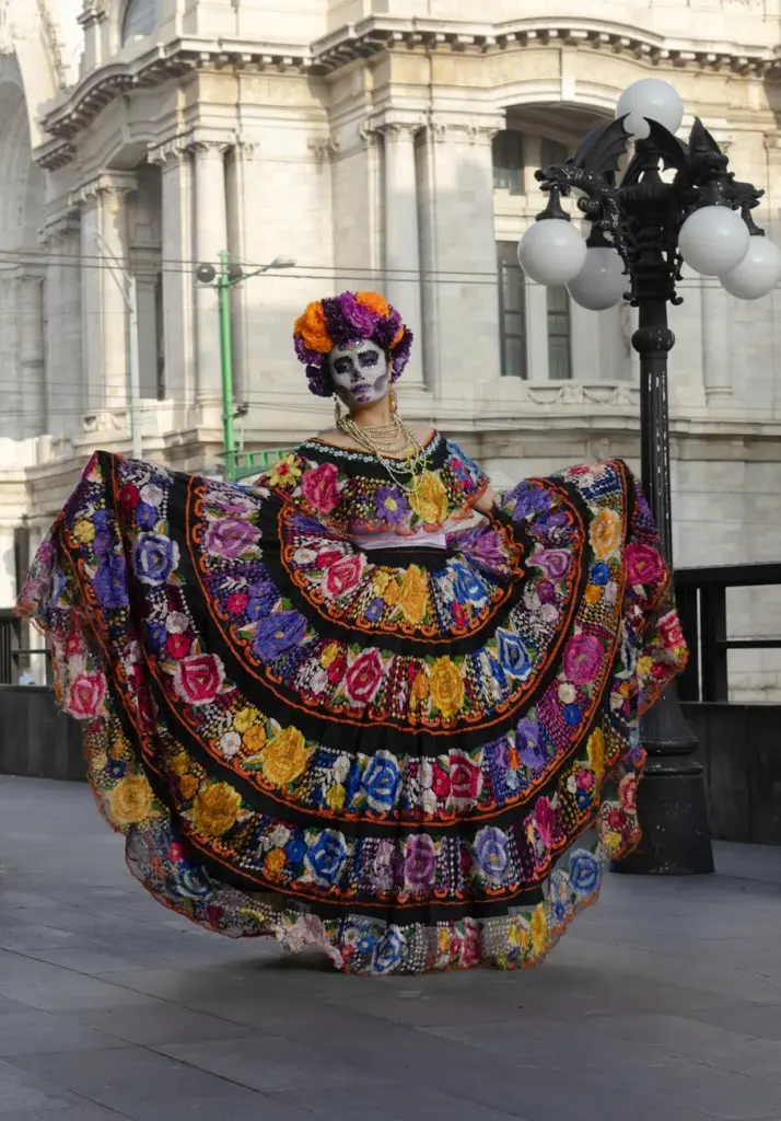 Colorful traditional dress and face paint for Dia de los Muertos in front of the Palacio de Bellas Artes.