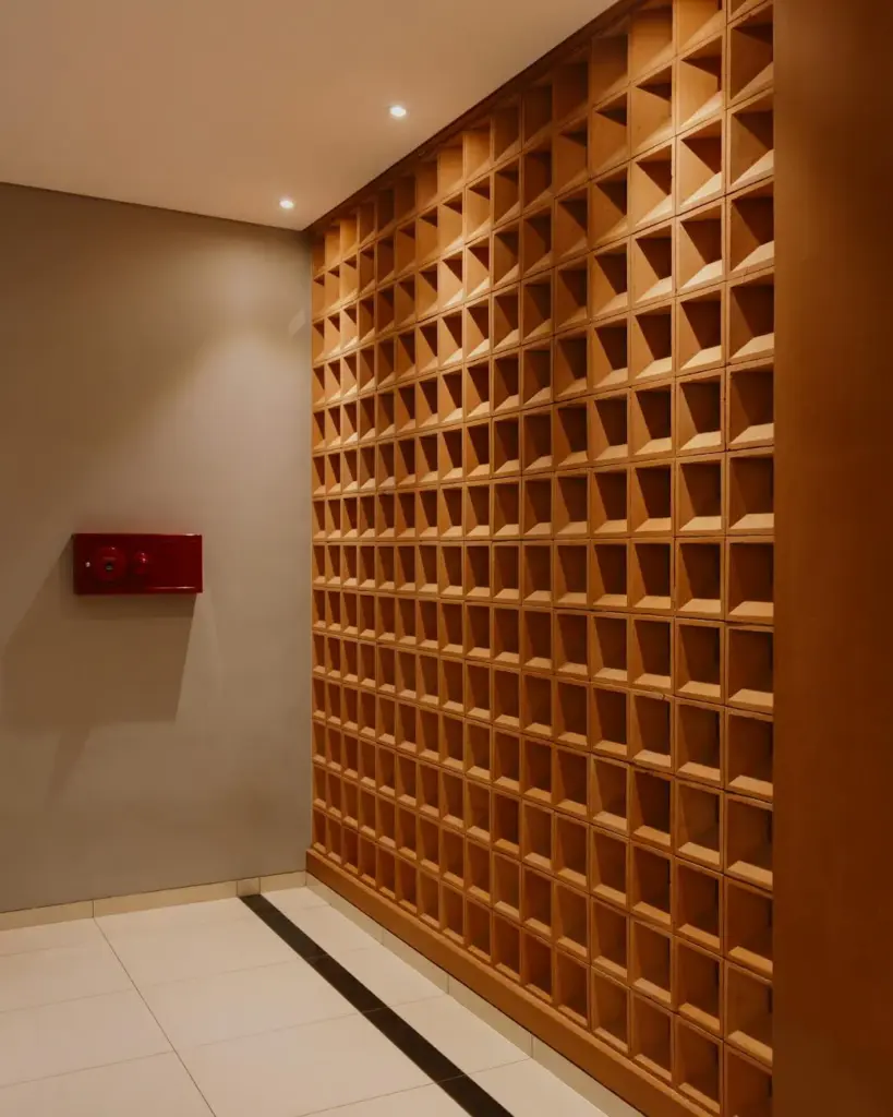 Stylish modern interior featuring a geometric wooden wall pattern and ambient lighting.