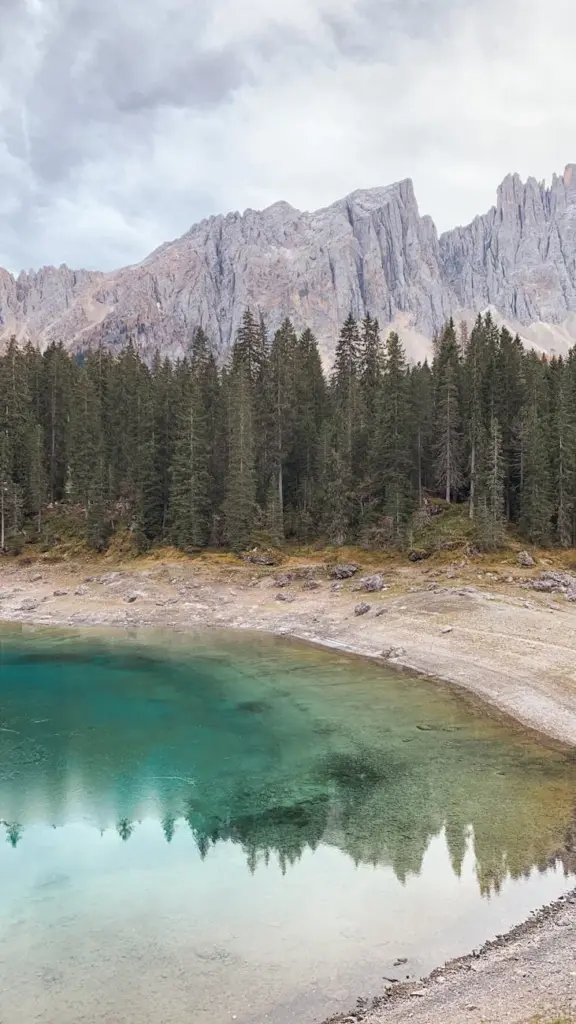Capture of Lake Carezza with the Dolomite mountains in Italy reflected in its clear waters.