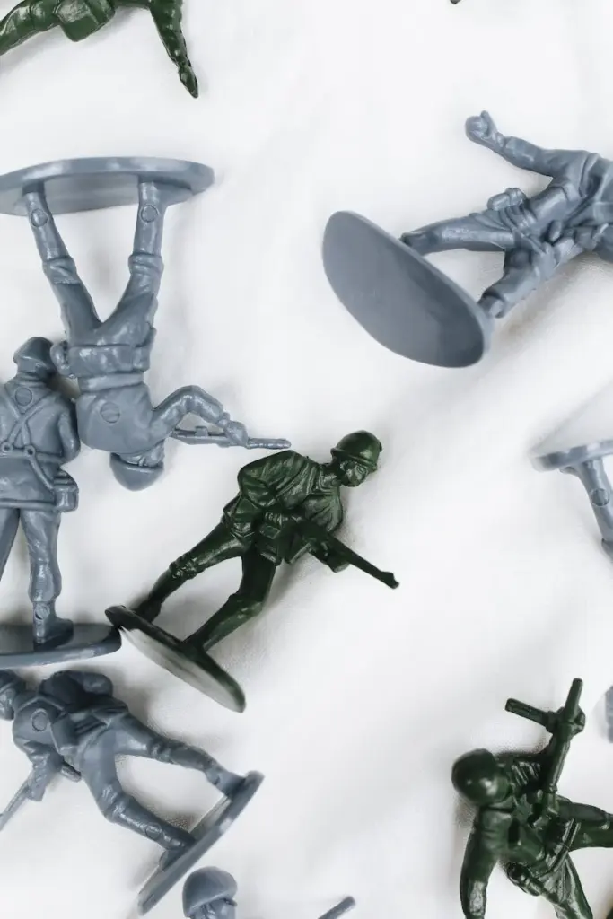 Top view of assorted plastic toy soldiers with varied poses, set against a white background.