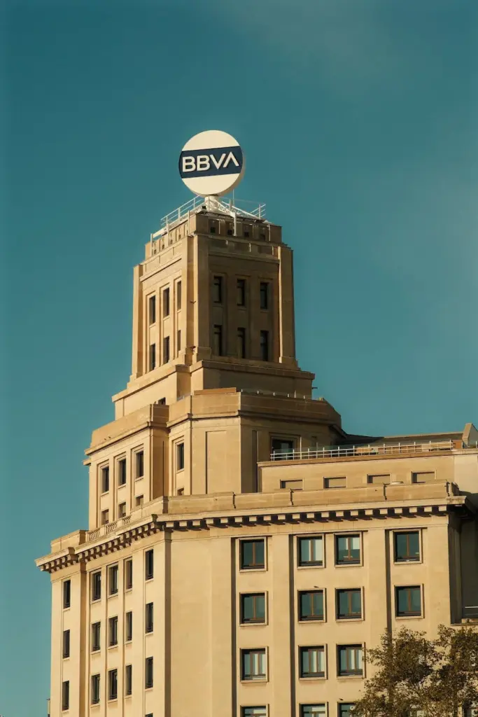 The BBVA building stands prominently with a clear blue sky backdrop.