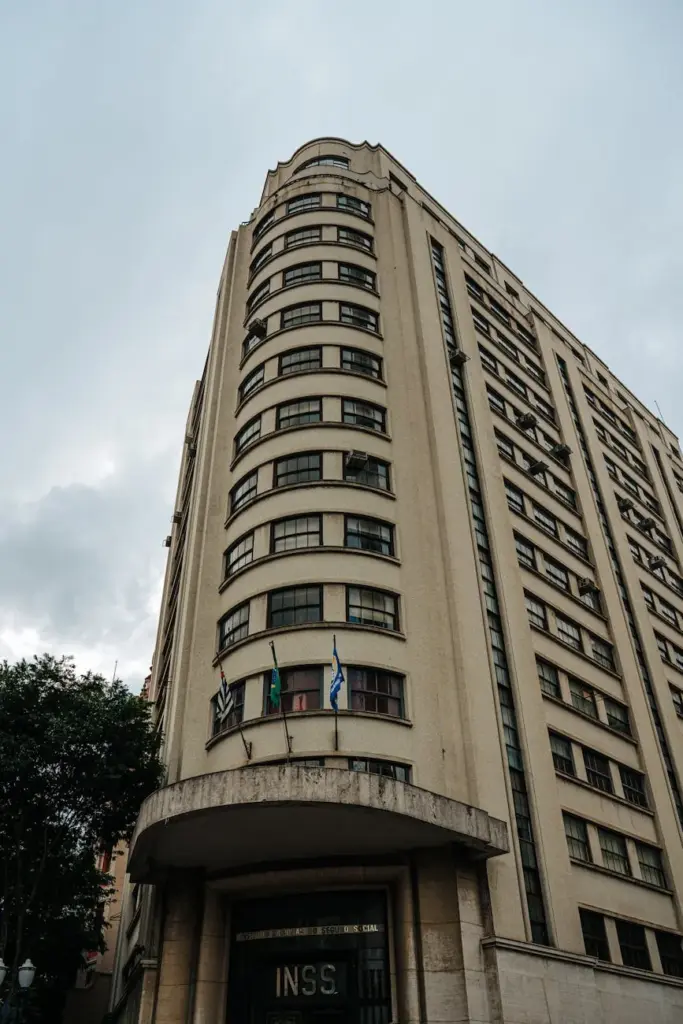 Tall historical building with flags in São Paulo, Brazil, showcasing unique architectural style.