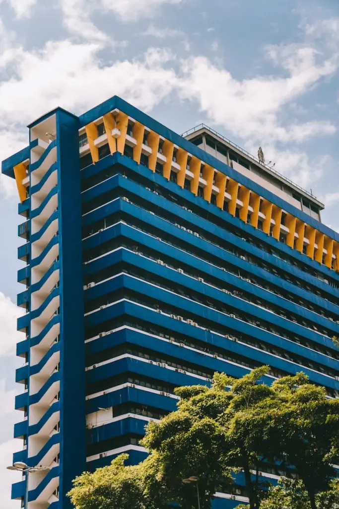 Contemporary skyscraper against blue sky in Kuala Lumpur, Malaysia, features bold architecture.