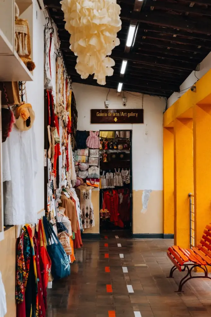 Vibrant art gallery entrance in Natal, Brazil, featuring colorful fabrics and clothing on display.