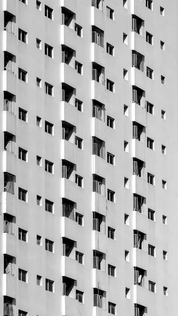 Striking black and white photo of modern building facade in Dubai featuring urban geometry.