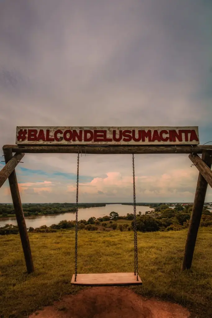 Peaceful landscape view from the Balcon del Usumacinta swing overlooking a vast river and horizon.