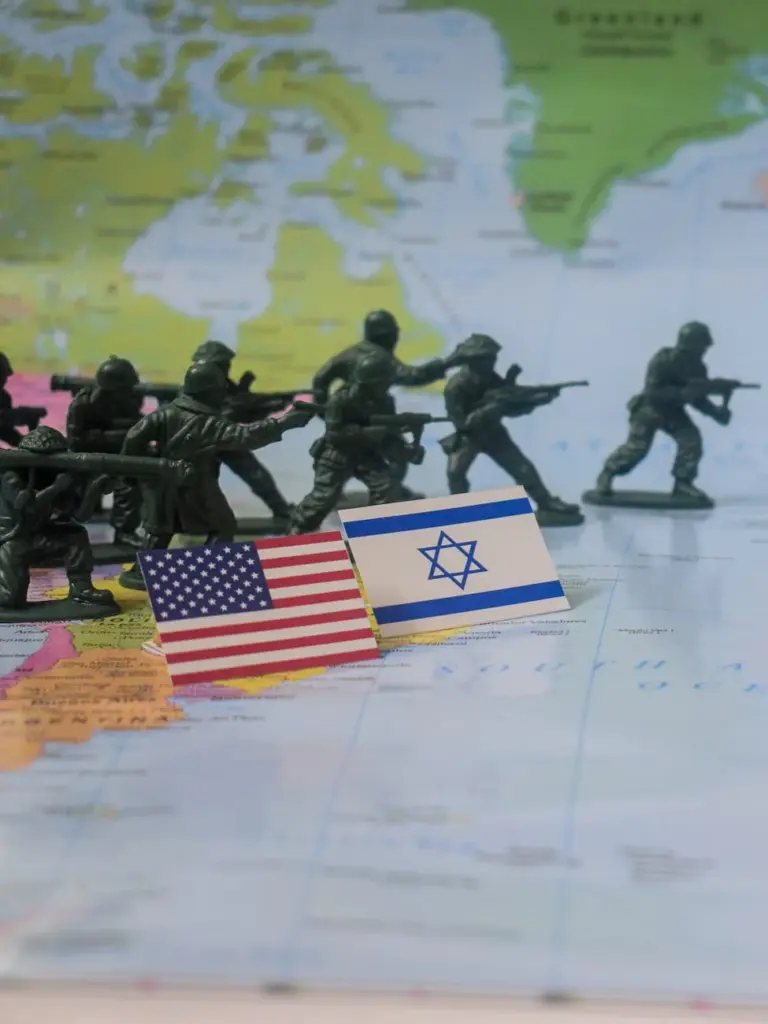 Toy soldiers with USA and Israel flags on a world map, depicting a geopolitical concept.