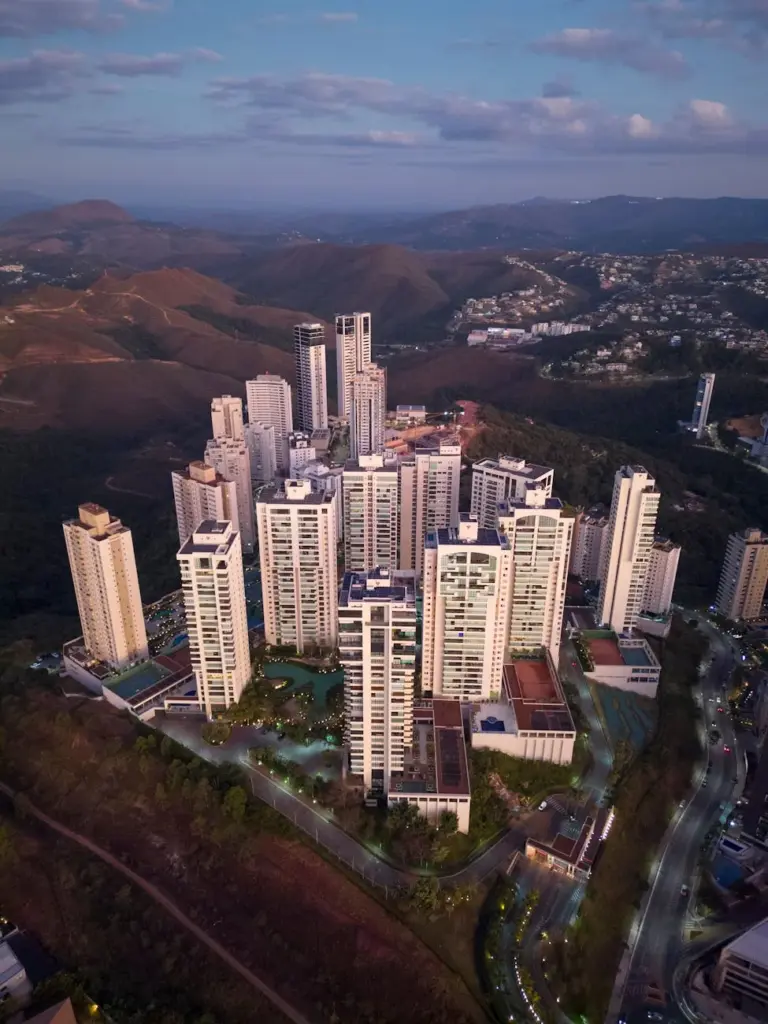 Stunning aerial view of skyscrapers amidst mountains in Belo Horizonte at twilight.