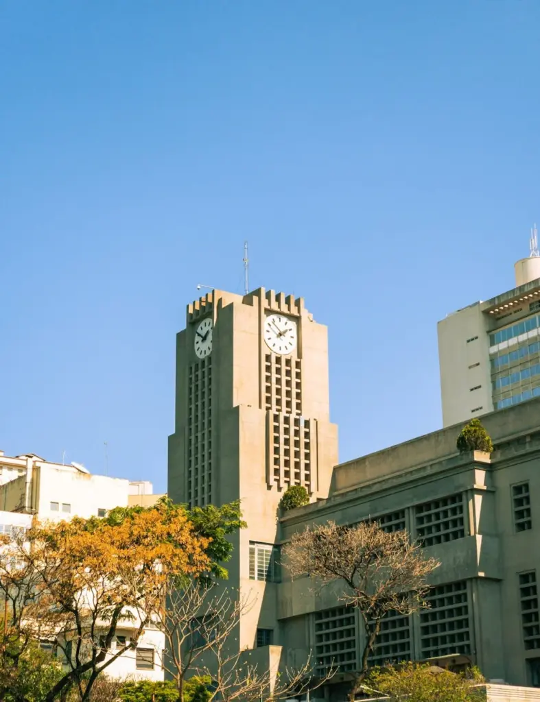 A classic clock tower set against a blue sky in Belo Horizonte, Brazil.