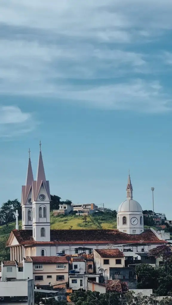 Stunning view of a historic basilica amidst a Brazilian town with clear skies.