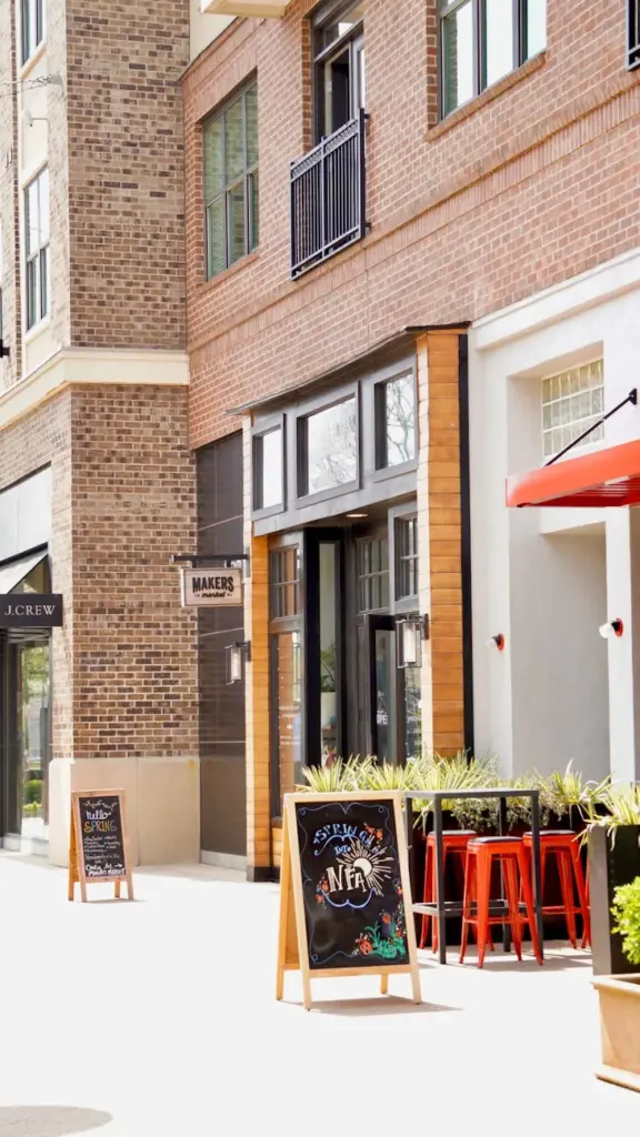 Bright urban street view with charming cafes and signage in front of brick buildings. Ideal for lifestyle and travel themes.