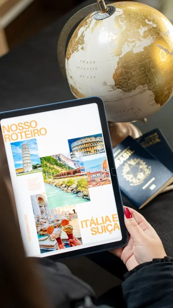 Person planning a trip to Italy and Switzerland using a tablet and globe.