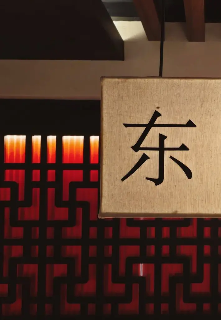 A beautifully designed oriental lamp with a red backdrop, showcasing traditional Chinese decorative elements.