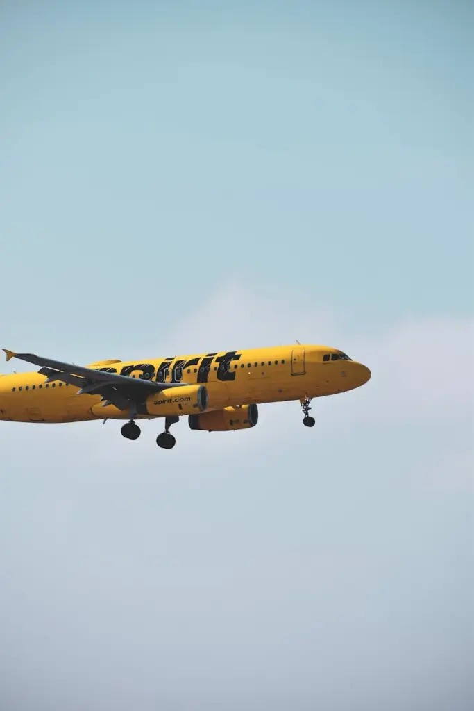 Bright yellow airplane soaring through the sky, capturing the essence of modern air travel.