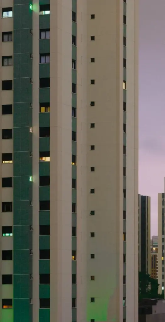 Tall modern high-rise buildings with glass windows in an urban setting.
