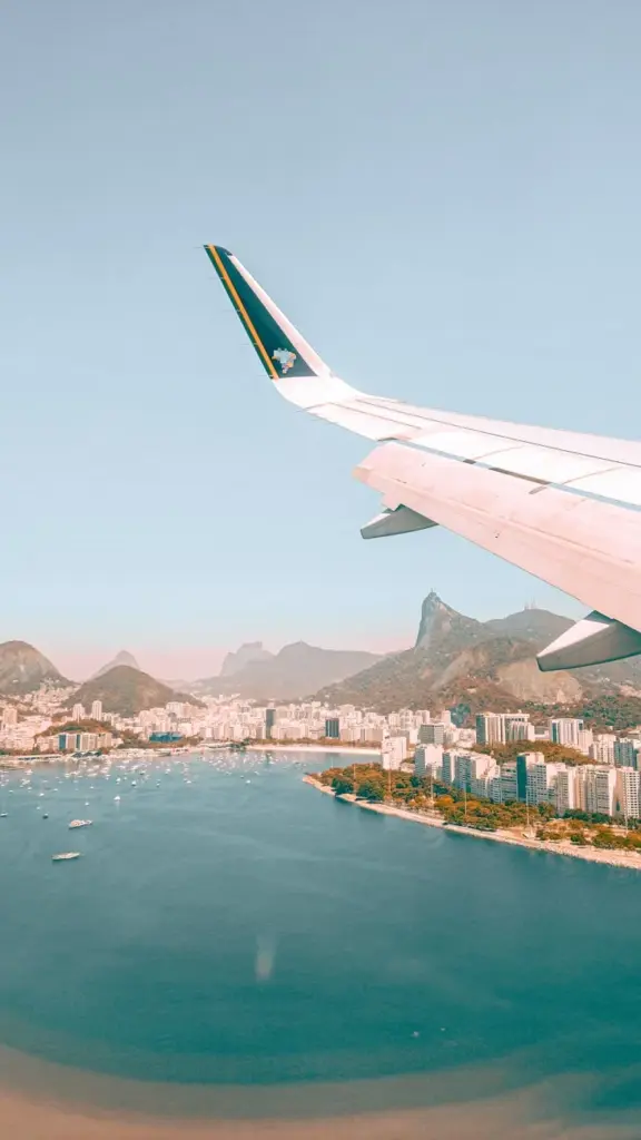 Scenic aerial view of Rio de Janeiro with Sugarloaf Mountain from an airplane window.