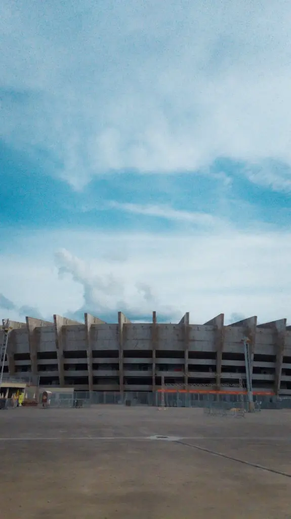 Exterior view of Mineirao Stadium in Belo Horizonte, Brazil, with clear blue skies and architectural concrete facade.