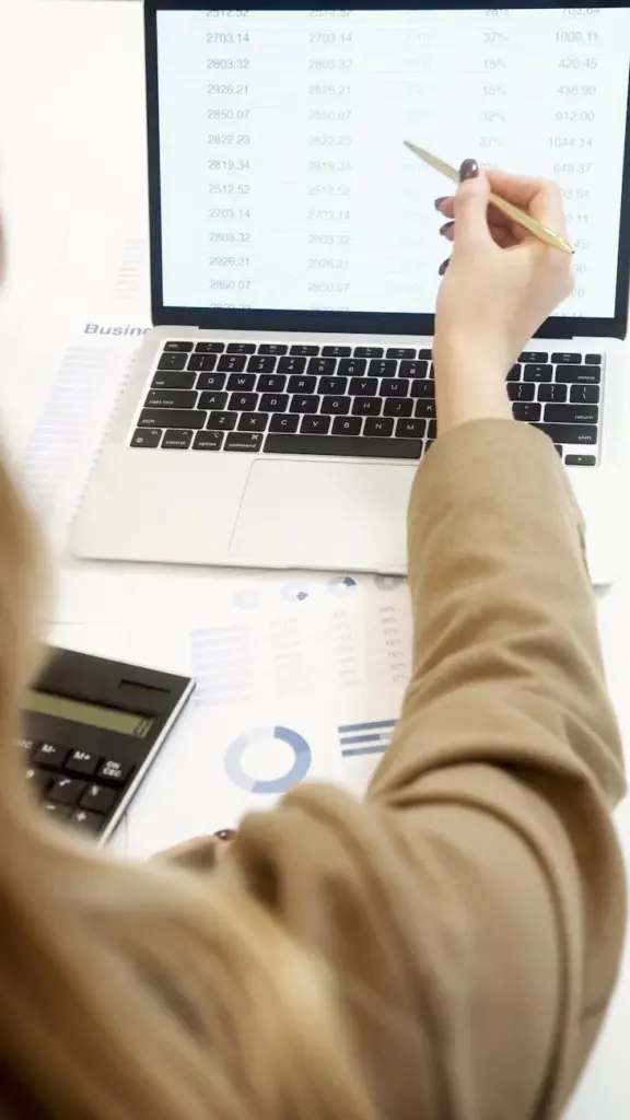 Business professional analyzing financial data on a laptop for strategic decision making.